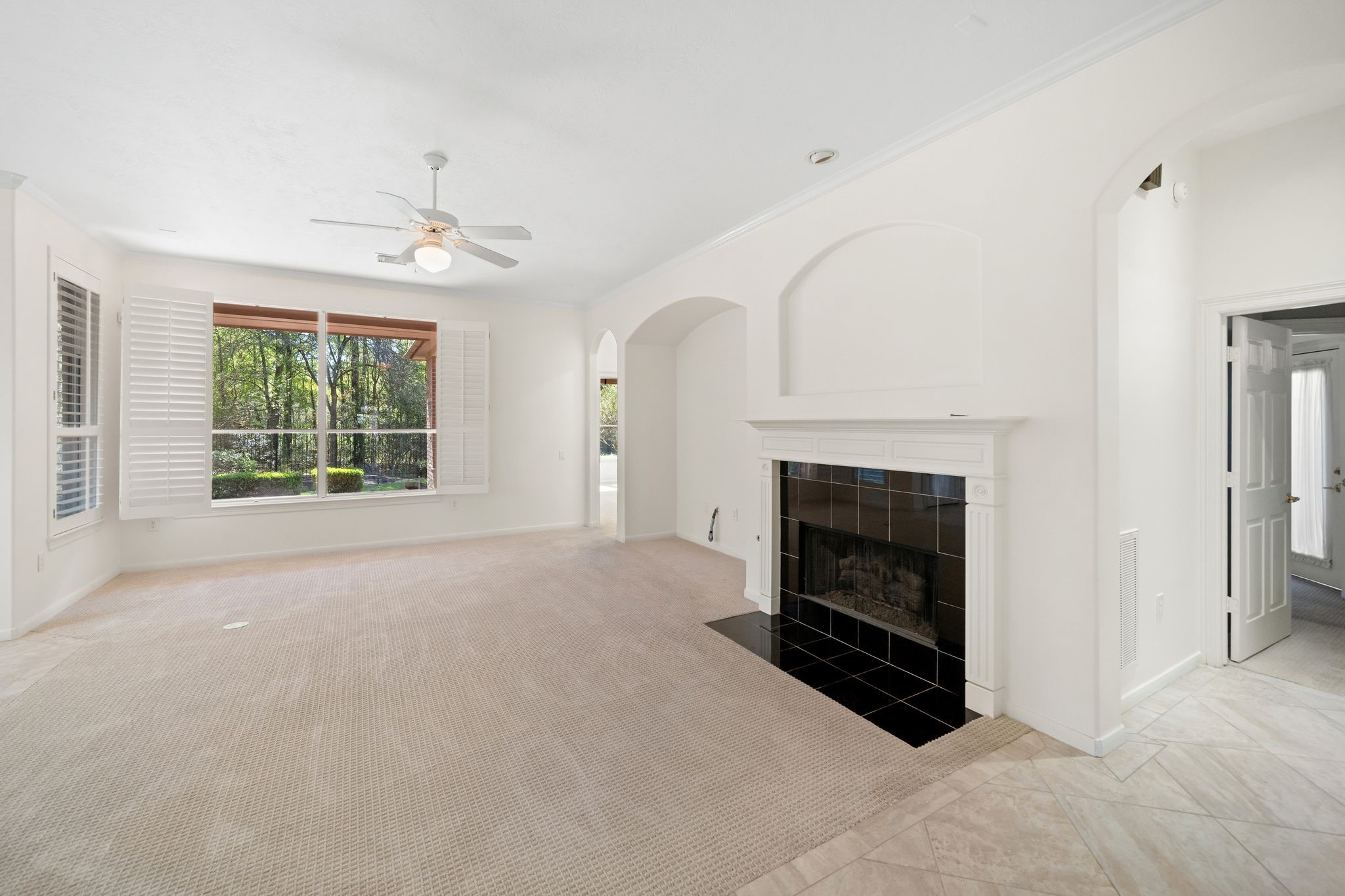 7 Sovereign Way Conroe, TX 77384 - Photo 8 of 31 a view of an empty room with a fireplace and a window