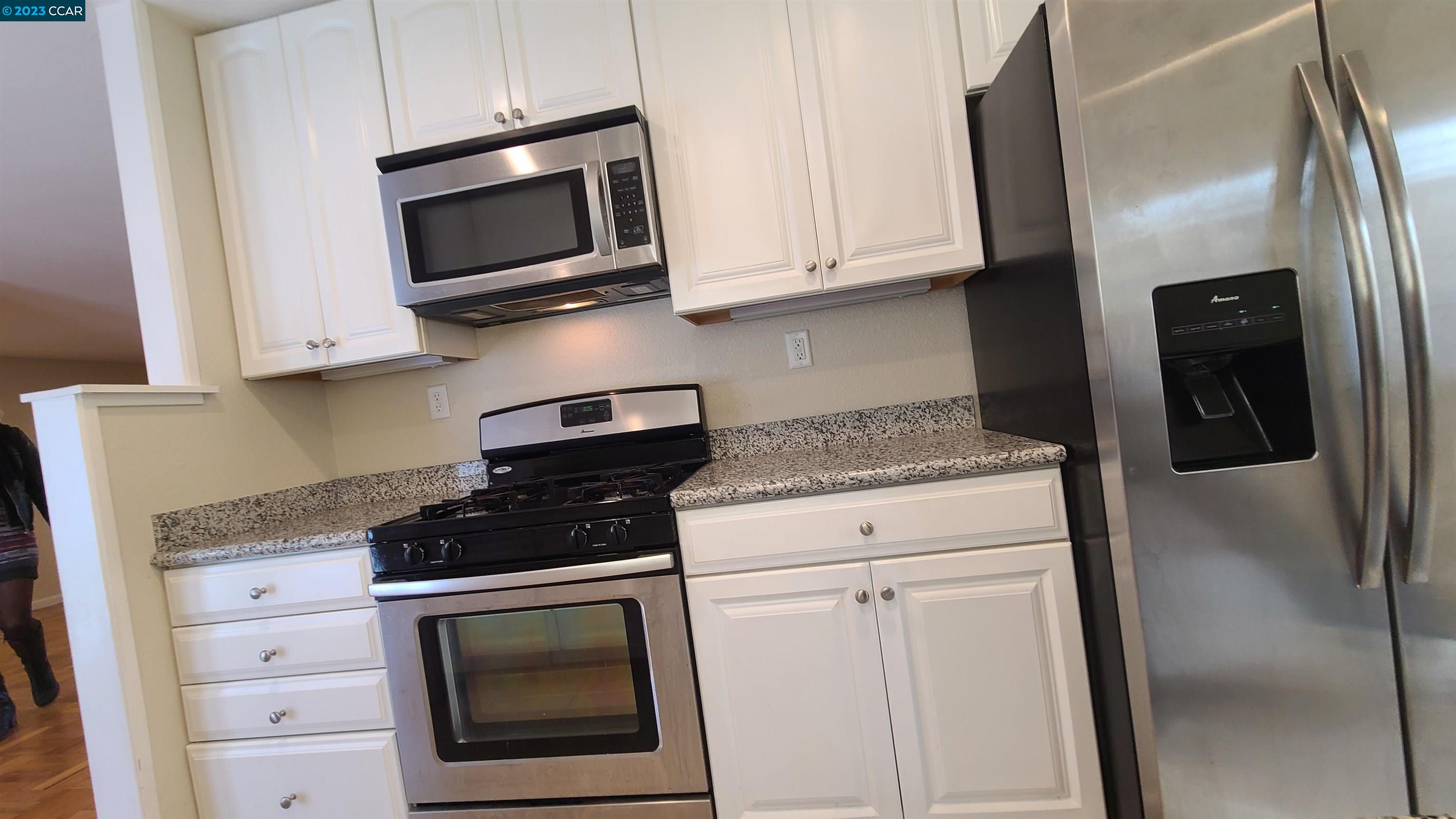 1972 Helen Road Pleasant Hill, CA 94523 - Photo 12 of 15 a kitchen with stainless steel appliances granite countertop a stove a microwave and a refrigerator