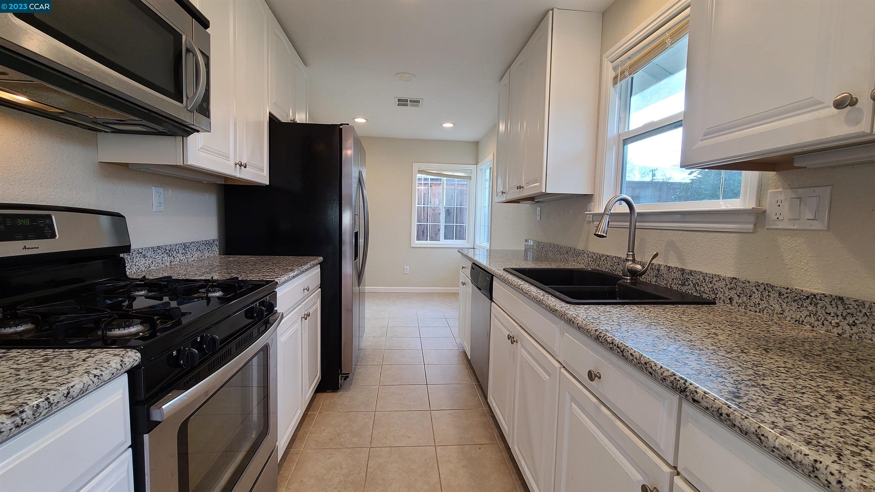 1972 Helen Road Pleasant Hill, CA 94523 - Photo 13 of 15 a kitchen with stainless steel appliances granite countertop a sink a stove and a refrigerator