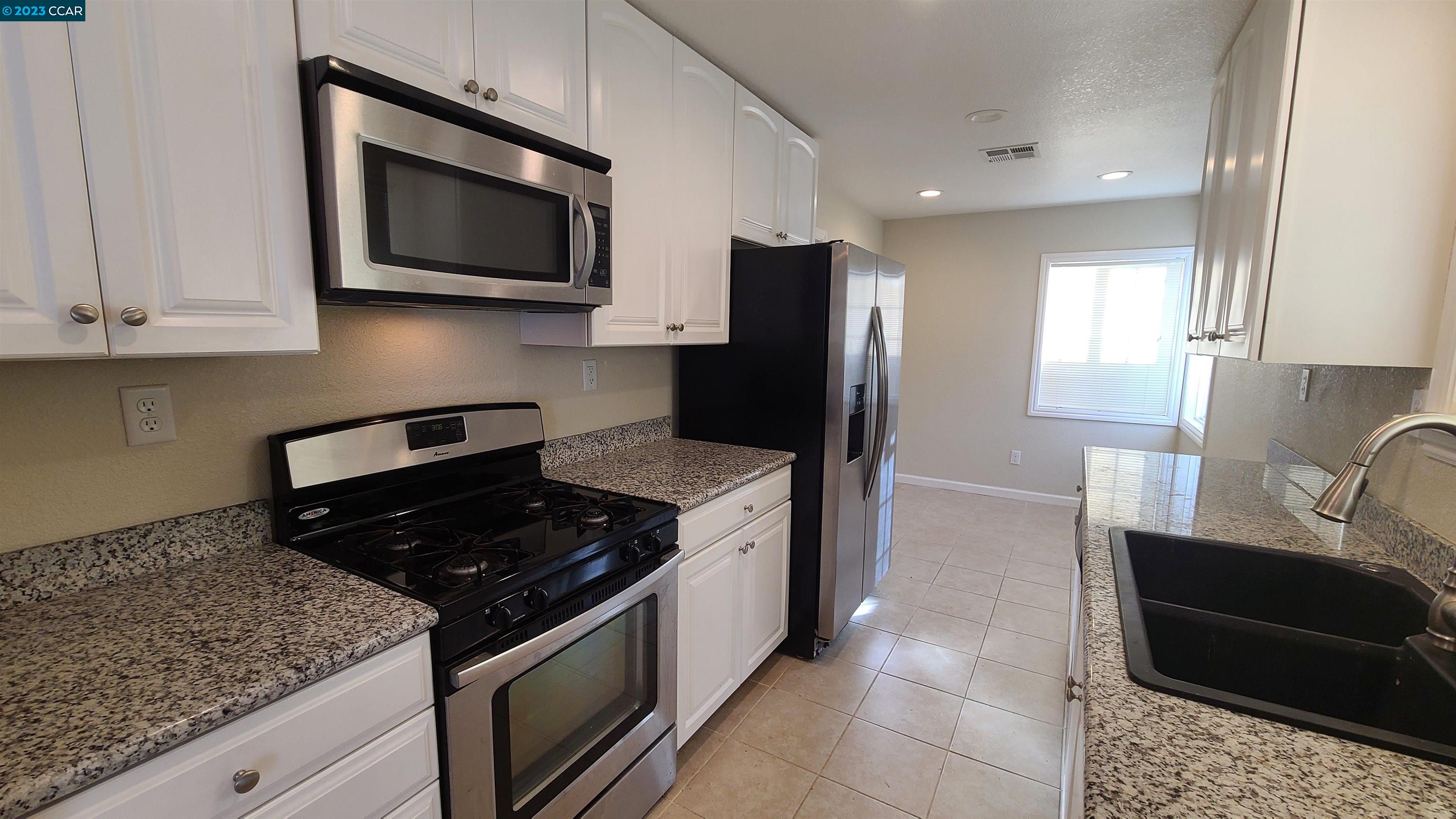 1972 Helen Road Pleasant Hill, CA 94523 - Photo 3 of 15 a kitchen with stainless steel appliances granite countertop a sink stove and microwave