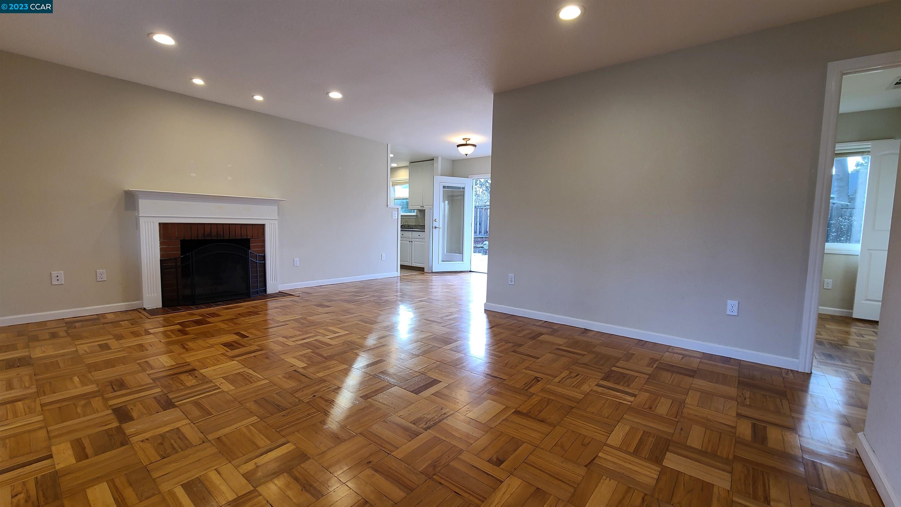 1972 Helen Road Pleasant Hill, CA 94523 - Photo 9 of 15 a view of an empty room with wooden floor and a fireplace