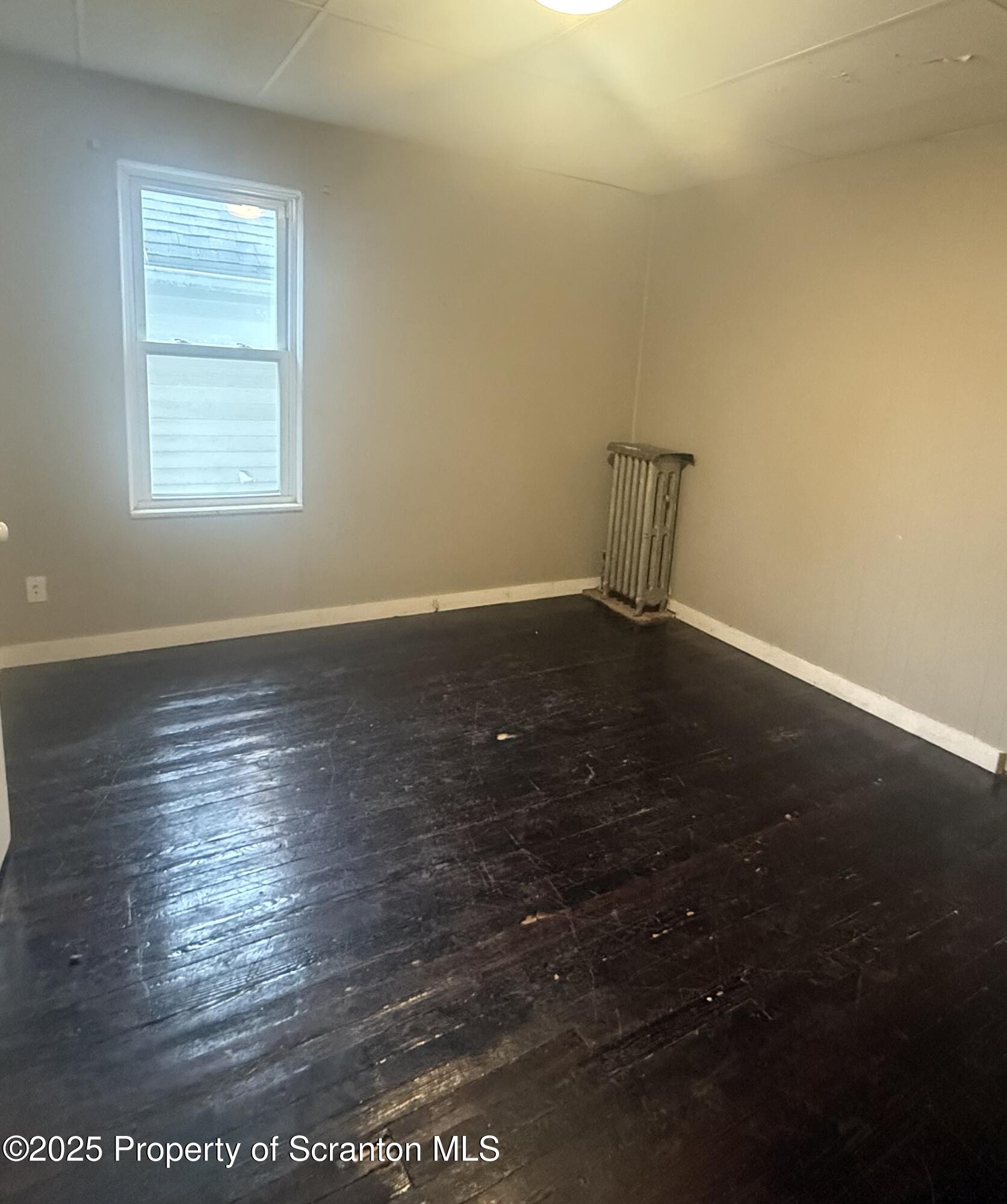 319 North Sumner Avenue Scranton, PA 18504 - Photo 11 of 13 an empty room with wooden floor and windows