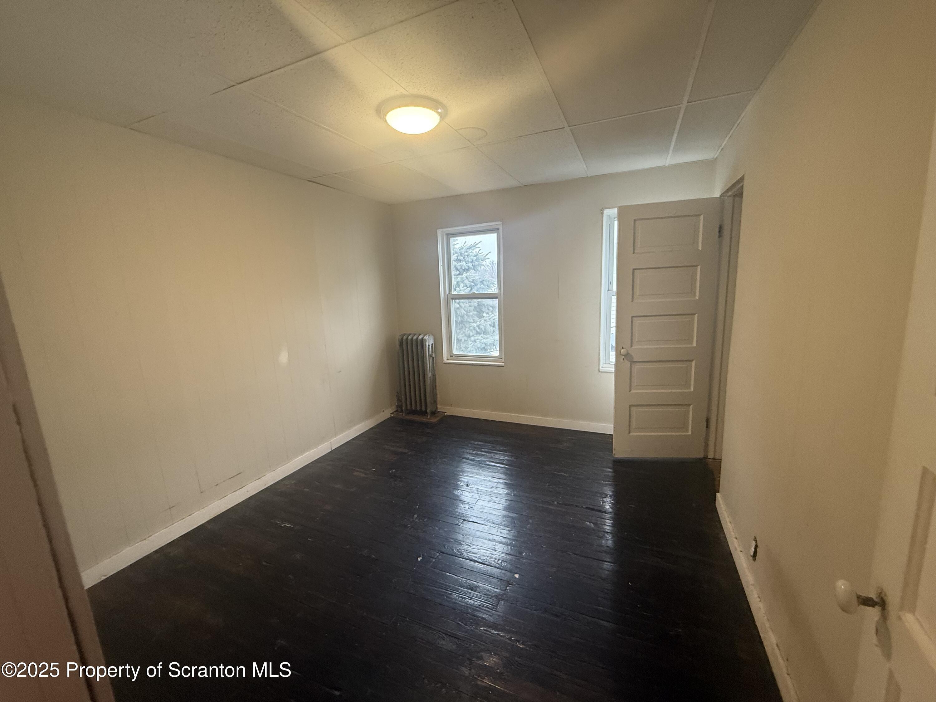 319 North Sumner Avenue Scranton, PA 18504 - Photo 12 of 13 an empty room with wooden floor and windows