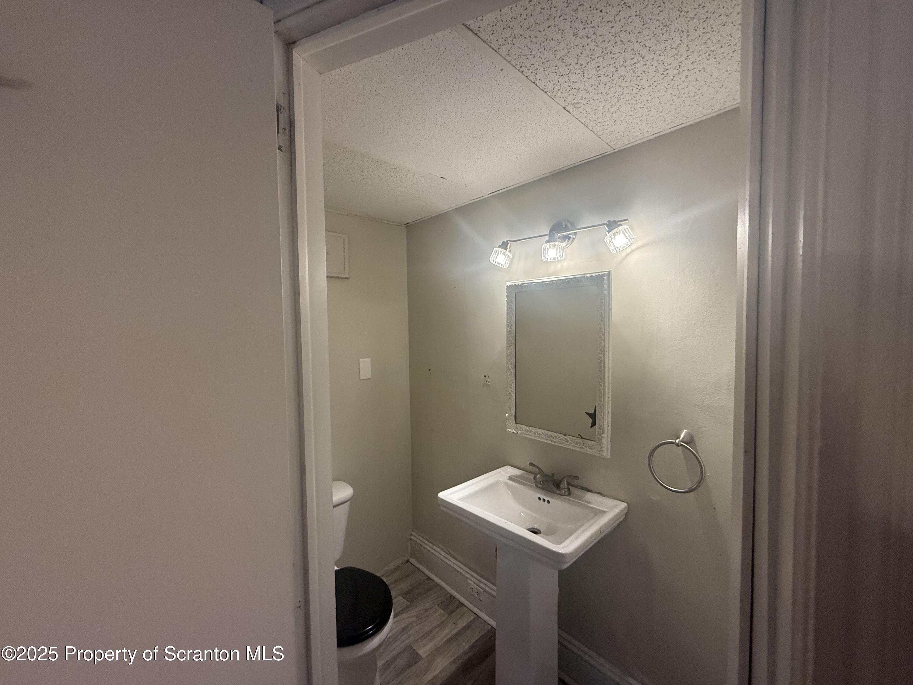 319 North Sumner Avenue Scranton, PA 18504 - Photo 4 of 13 a bathroom with a sink and mirror
