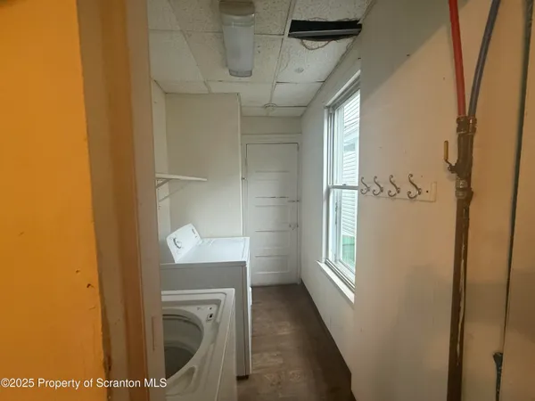 a view of a hallway with washer and dryer