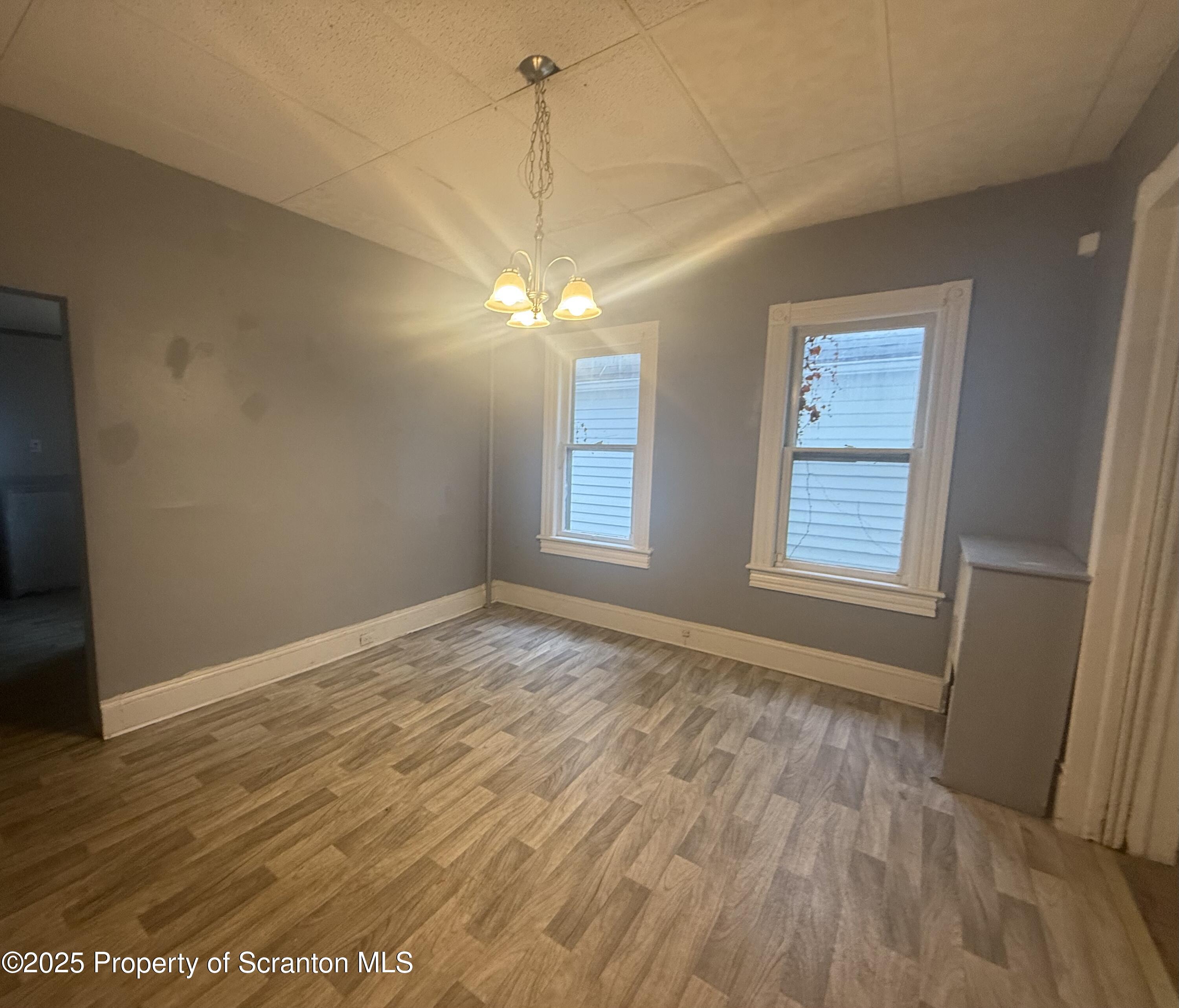 319 North Sumner Avenue Scranton, PA 18504 - Photo 7 of 13 an empty room with wooden floor and windows