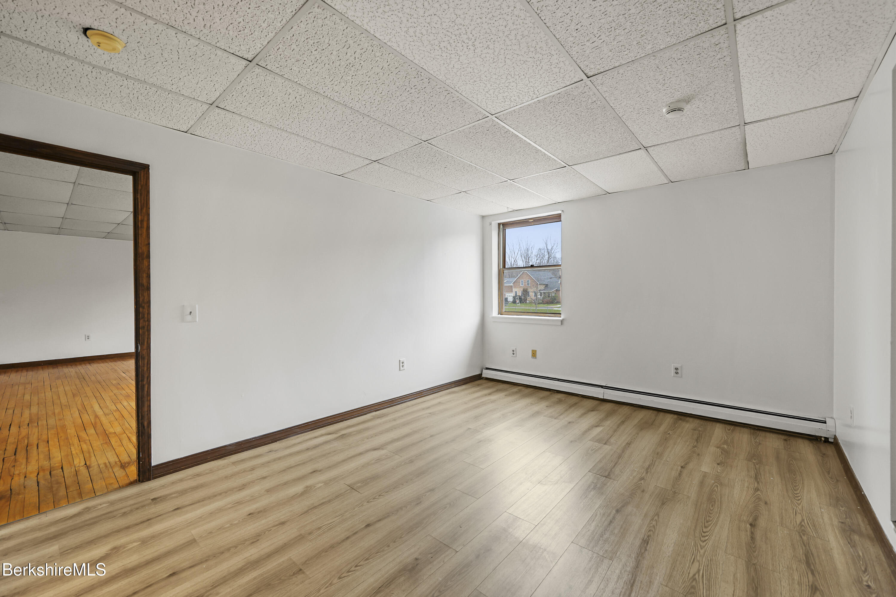 55 Crystal Street, Unit 8 Lenox, MA 01242 - Photo 10 of 12 a view of an empty room with wooden floor