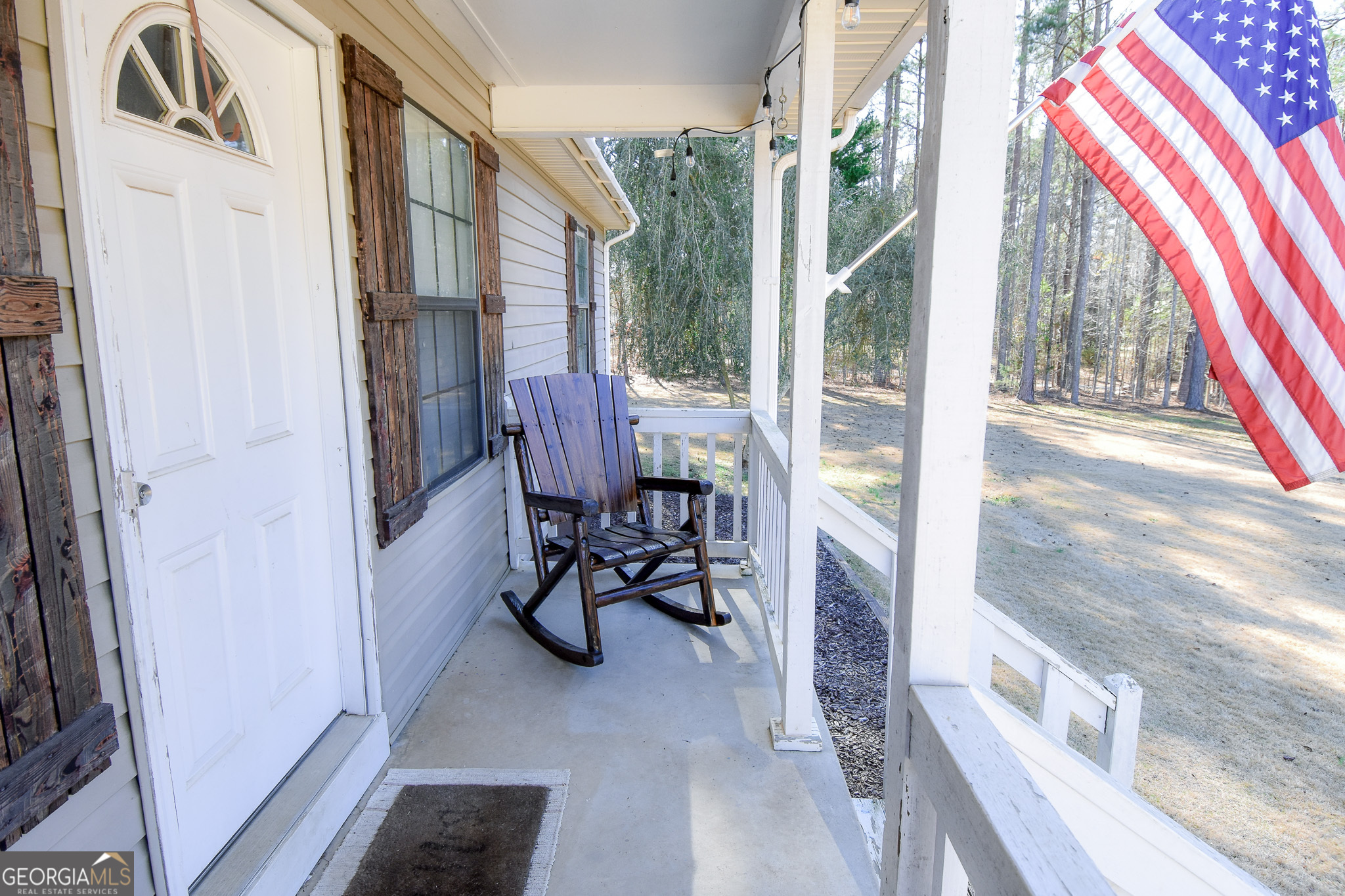 741 Howell Road Zebulon, GA 30295 - Photo 15 of 79 a view of a porch with chairs and couches next to a window