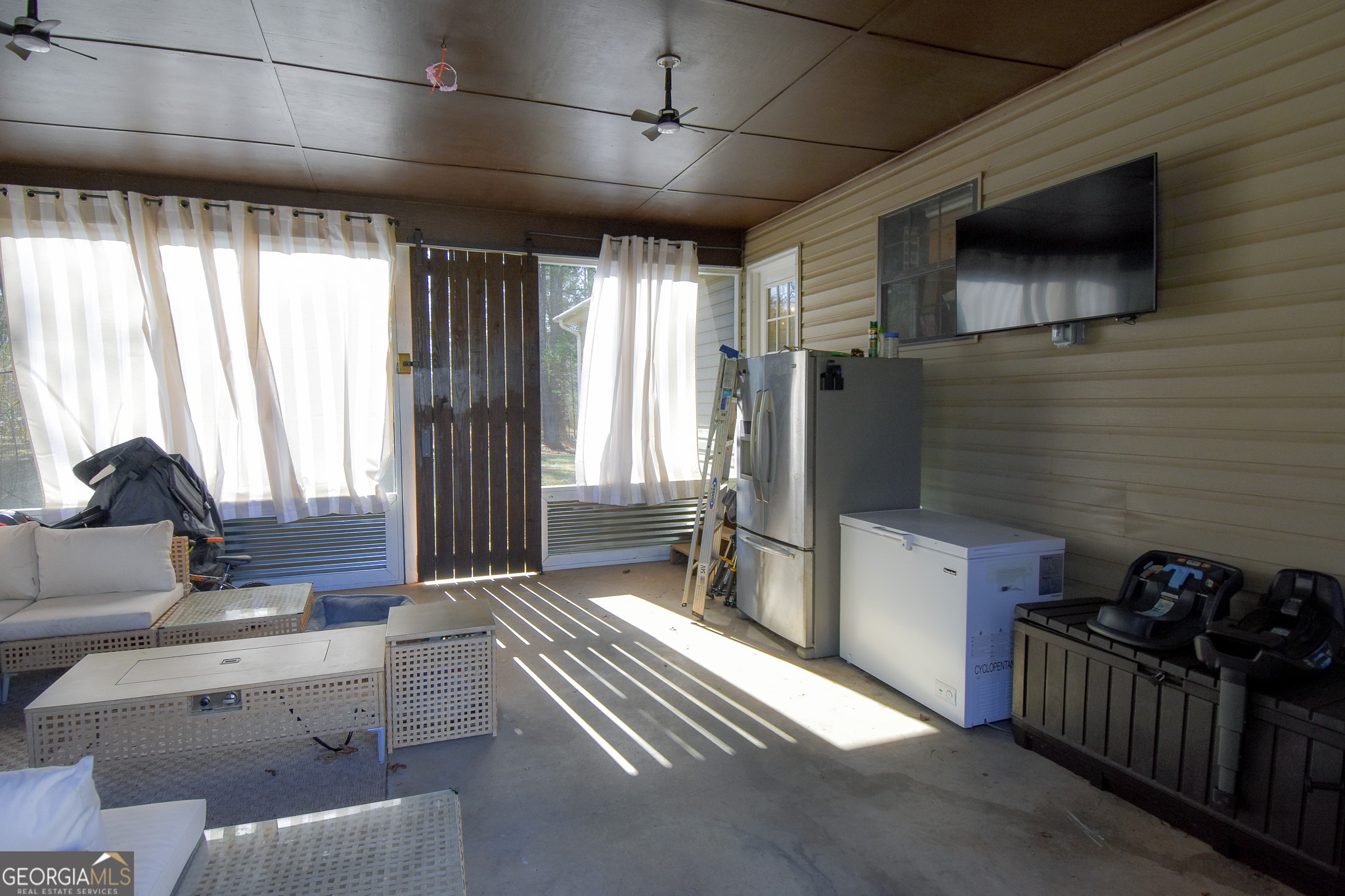 741 Howell Road Zebulon, GA 30295 - Photo 28 of 79 a living room with furniture and a flat screen tv