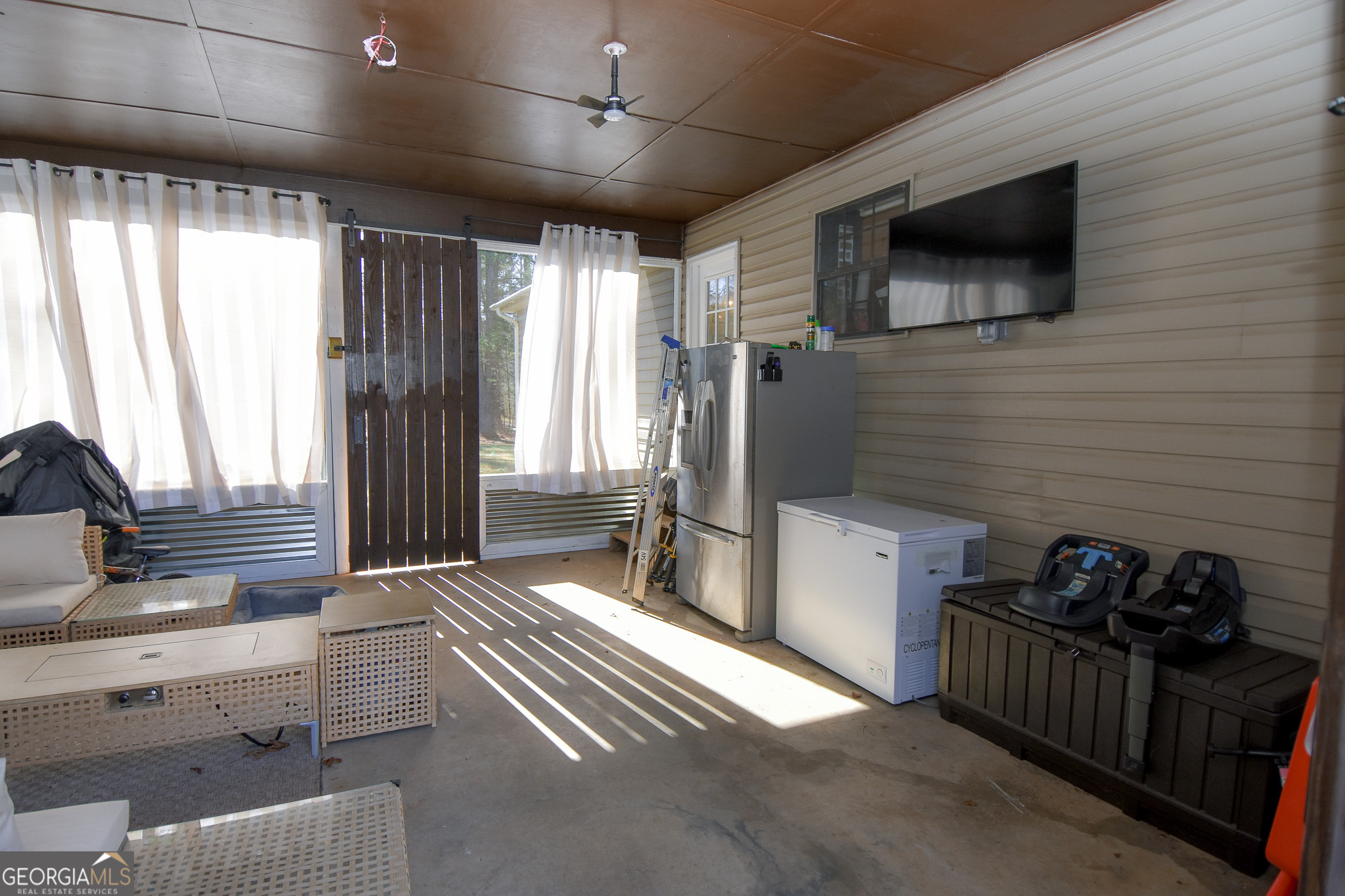741 Howell Road Zebulon, GA 30295 - Photo 30 of 79 a spacious bedroom with a bed and a flat screen tv