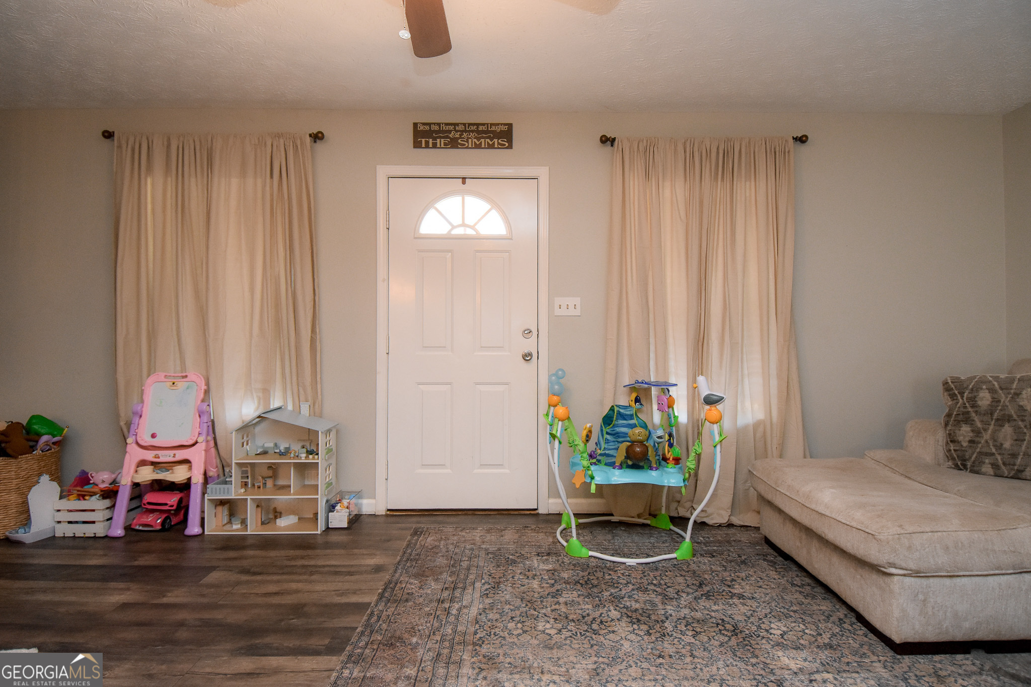 741 Howell Road Zebulon, GA 30295 - Photo 35 of 79 a living room with furniture and wooden floor