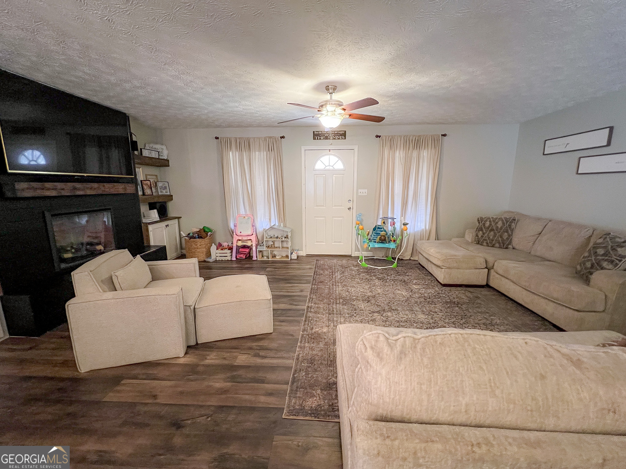 741 Howell Road Zebulon, GA 30295 - Photo 36 of 79 a living room with furniture and a fireplace