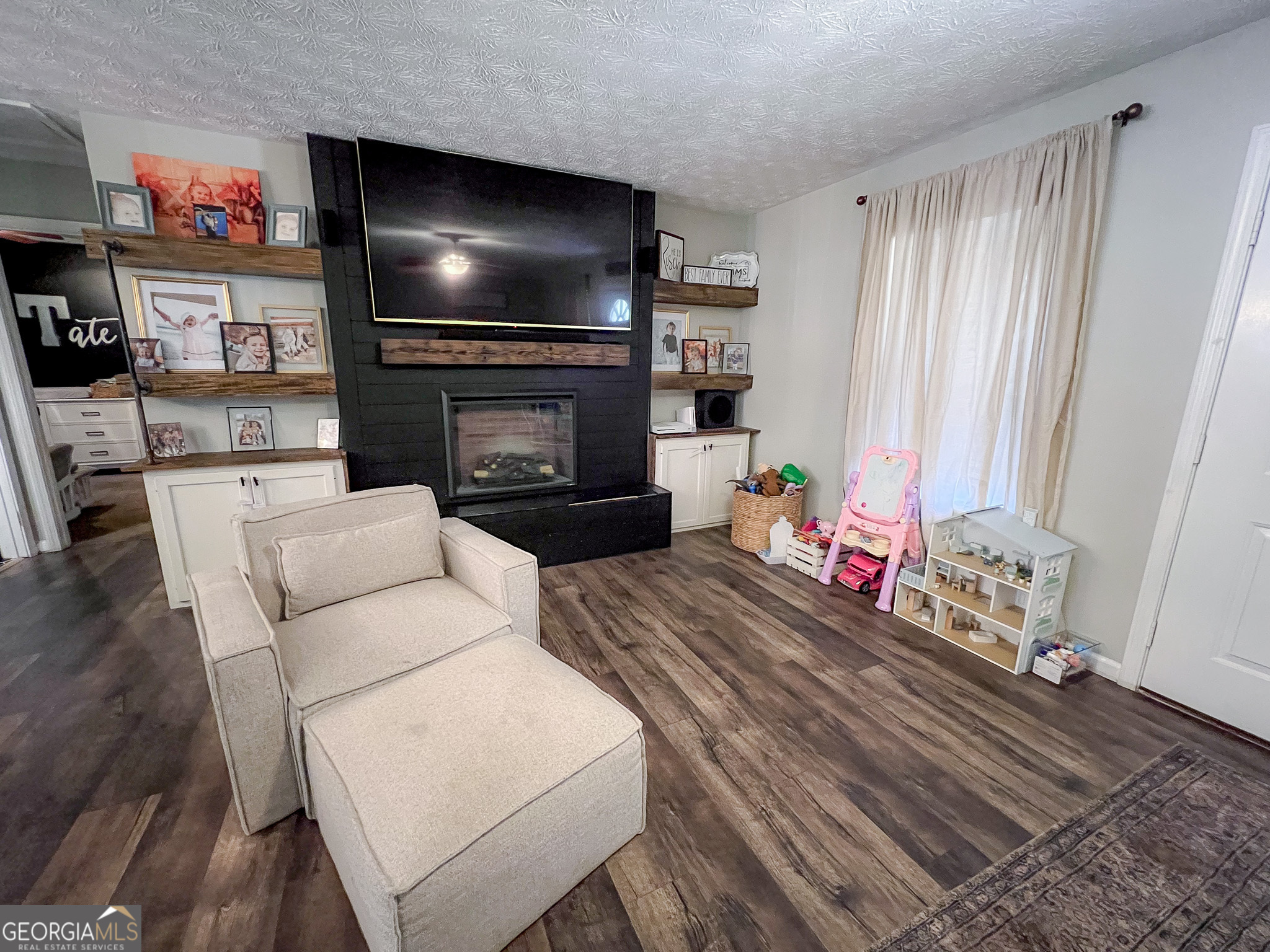741 Howell Road Zebulon, GA 30295 - Photo 37 of 79 a living room with furniture and a flat screen tv