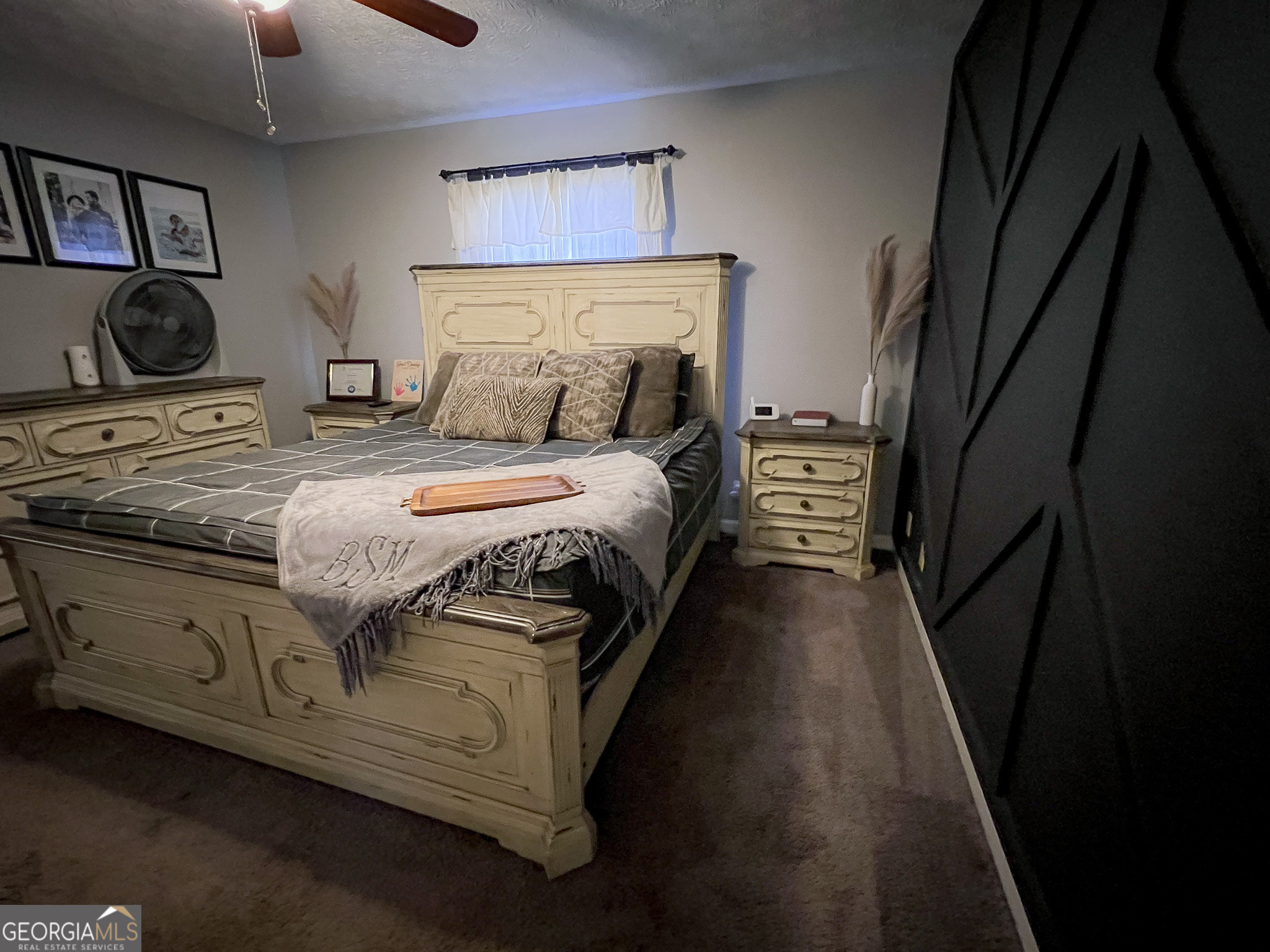 741 Howell Road Zebulon, GA 30295 - Photo 47 of 79 a bedroom with a bed and painting on the wall