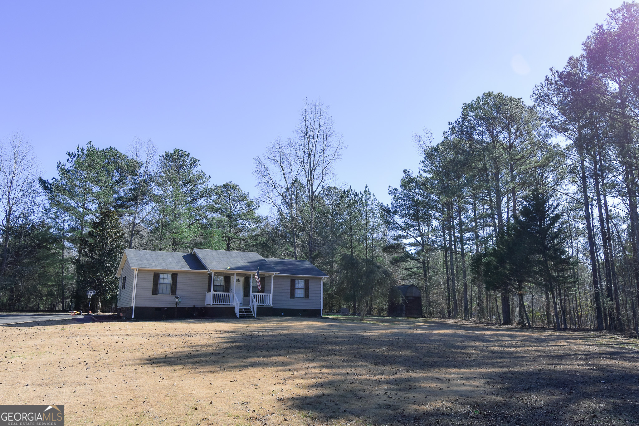 741 Howell Road Zebulon, GA 30295 - Photo 5 of 79 a front view of a house with a yard covered with snow and trees