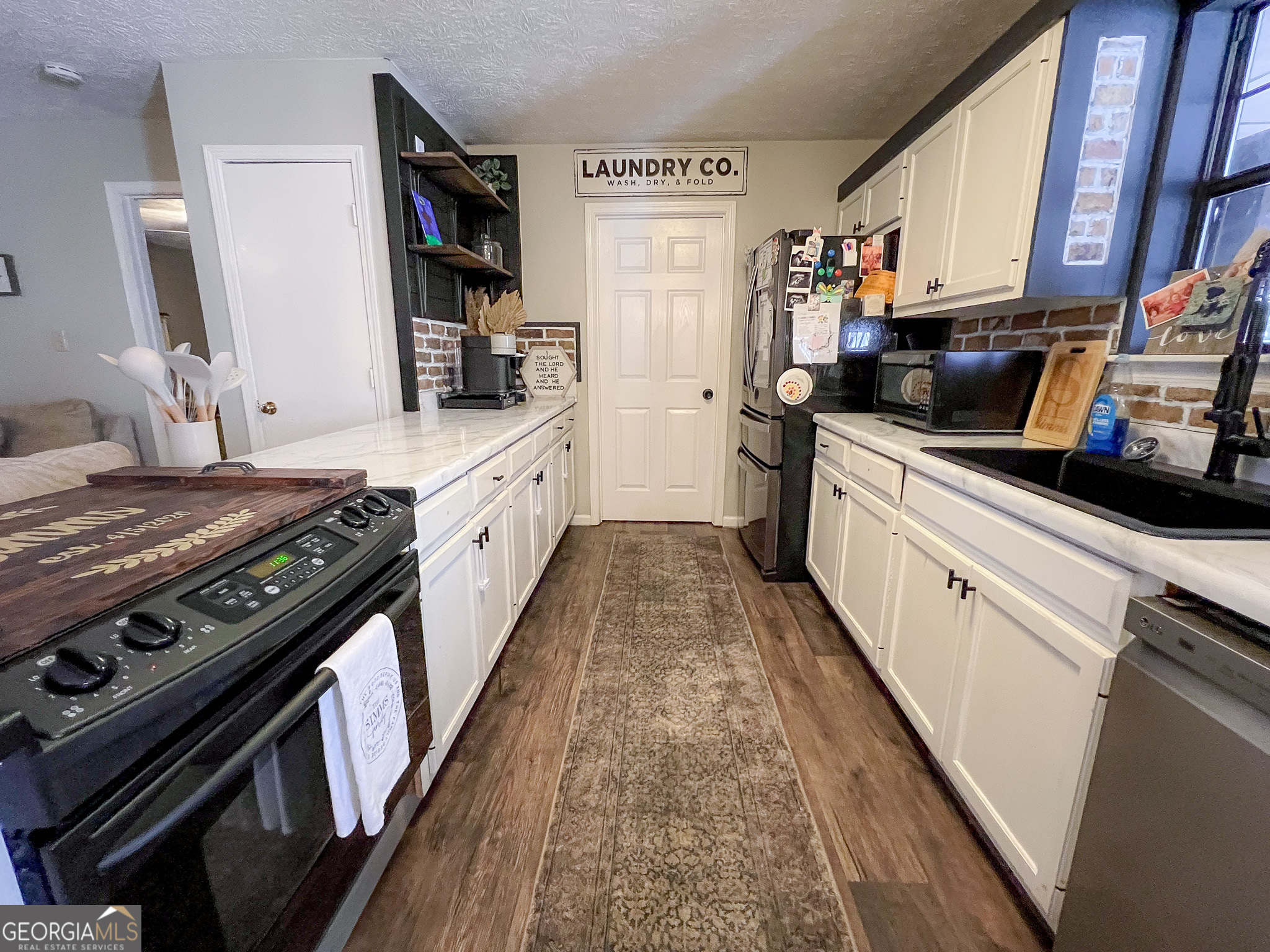 741 Howell Road Zebulon, GA 30295 - Photo 55 of 79 a large kitchen with stainless steel appliances granite countertop a stove and a sink
