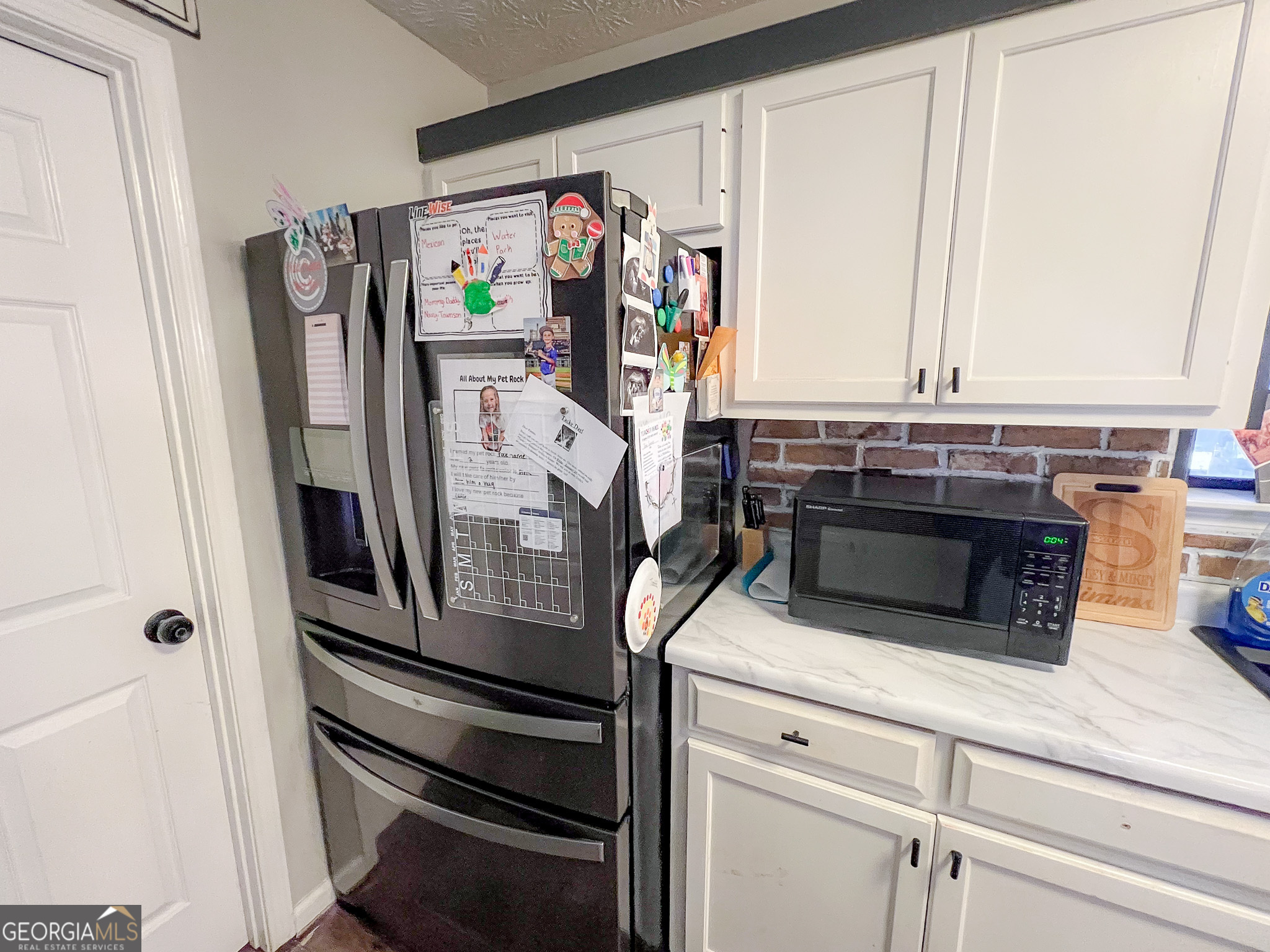 741 Howell Road Zebulon, GA 30295 - Photo 66 of 79 a kitchen with stainless steel appliances granite countertop a stove and a refrigerator