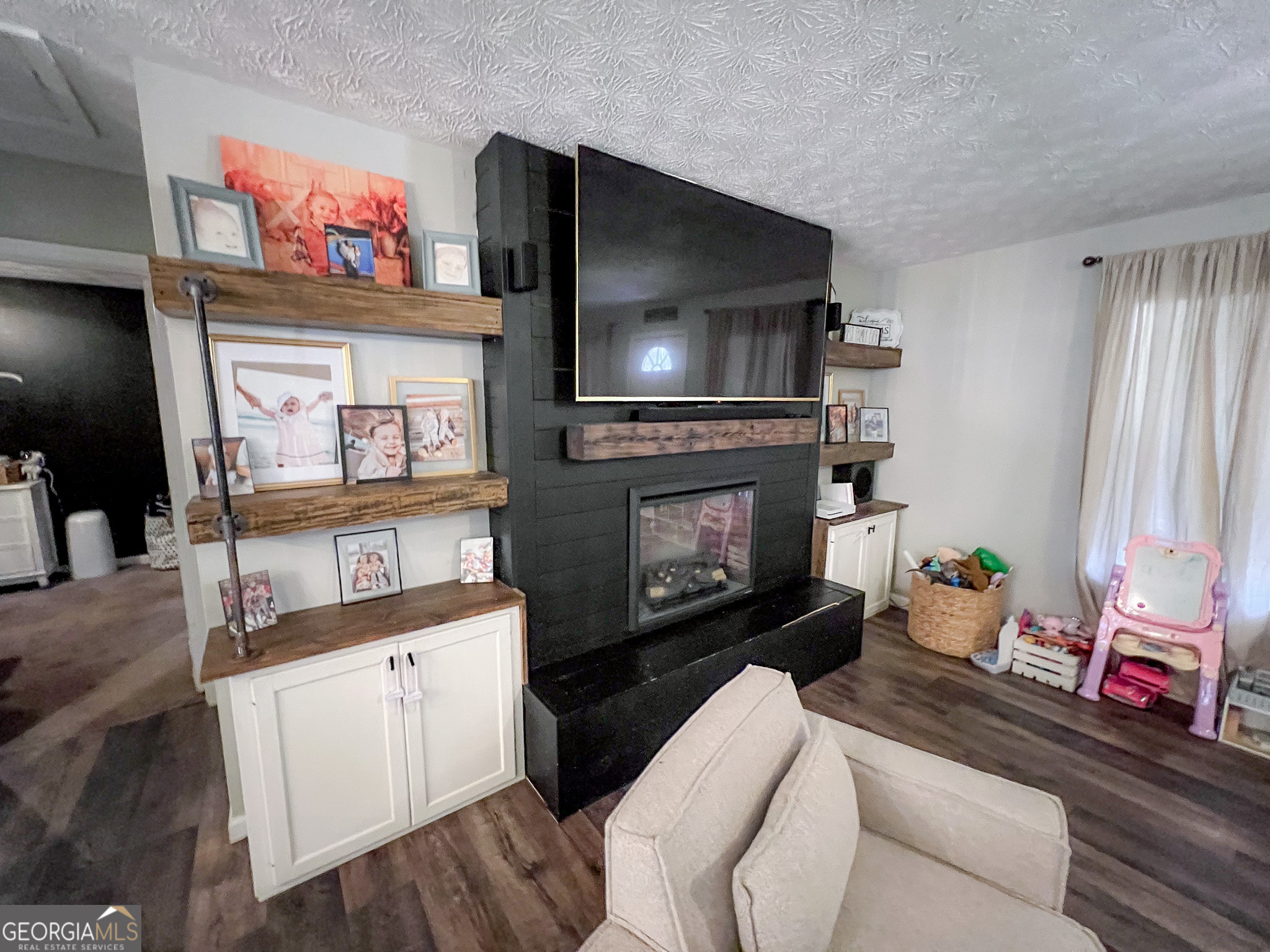 741 Howell Road Zebulon, GA 30295 - Photo 68 of 79 a living room with furniture and a flat screen tv