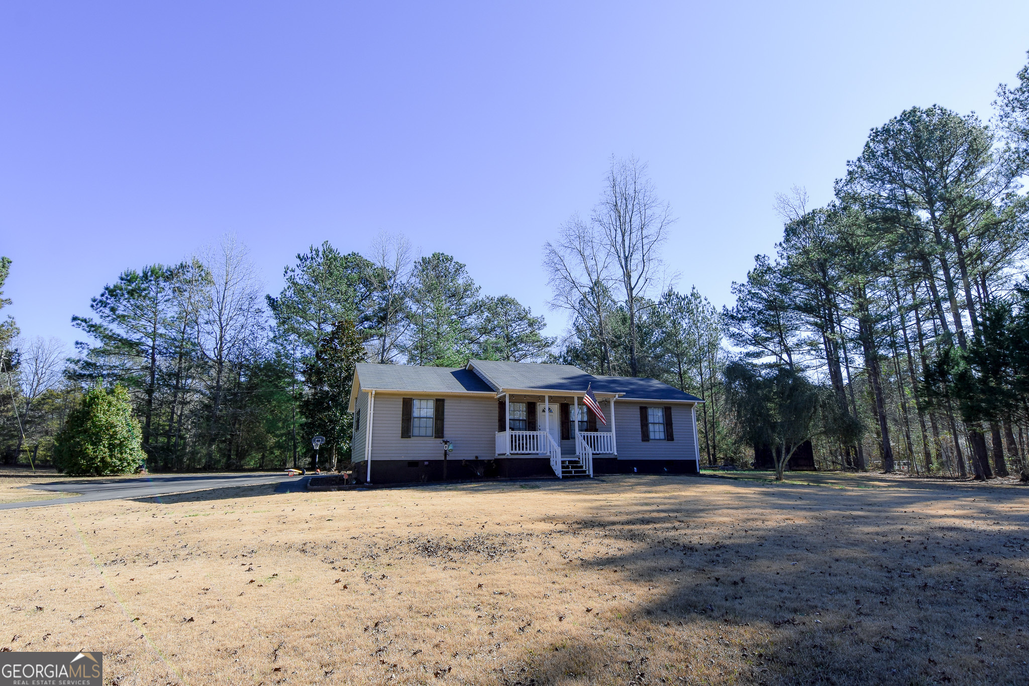 741 Howell Road Zebulon, GA 30295 - Photo 7 of 79 a front view of a house with a yard and trees
