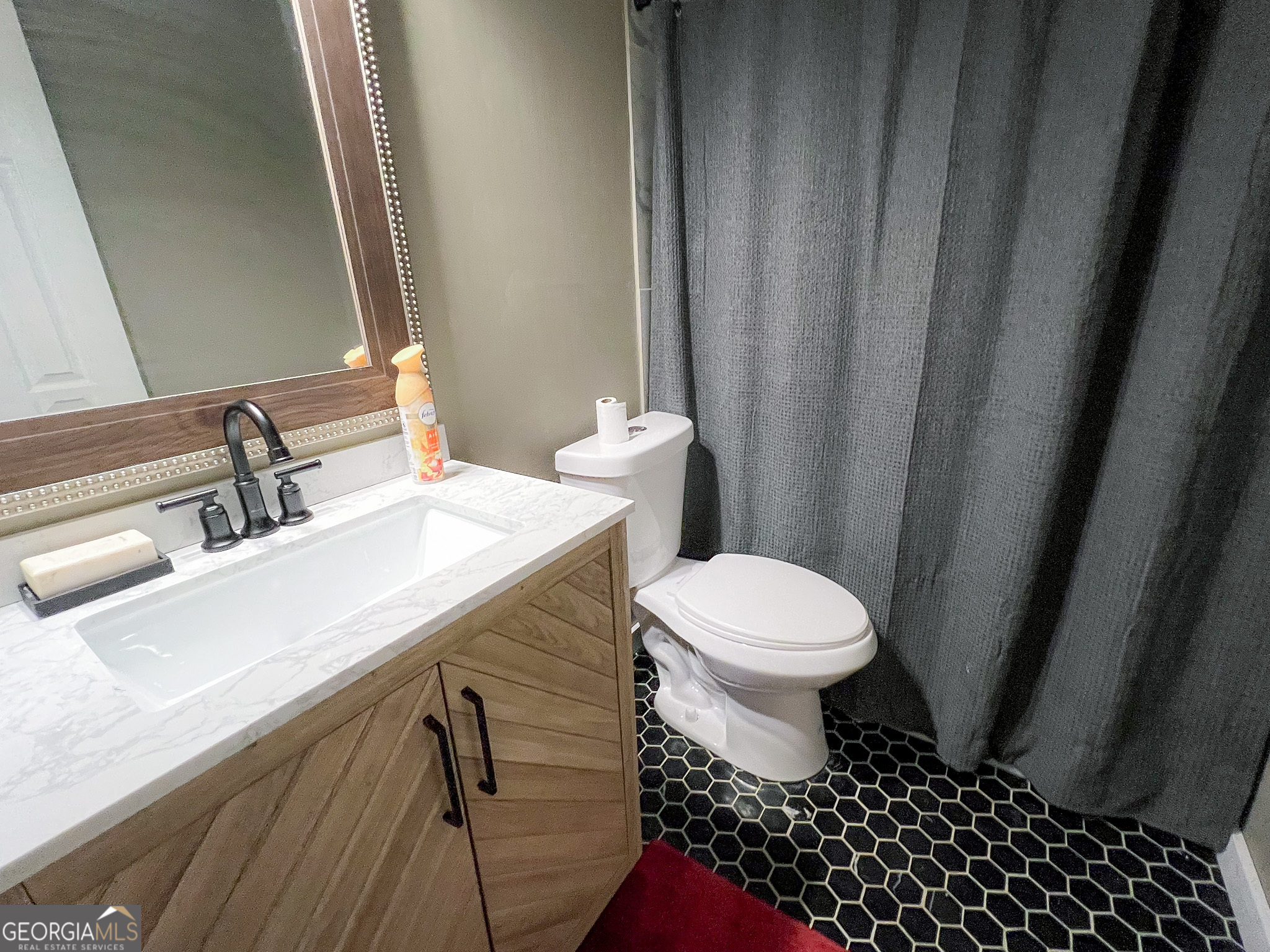 741 Howell Road Zebulon, GA 30295 - Photo 72 of 79 a bathroom with a sink a toilet and a mirror