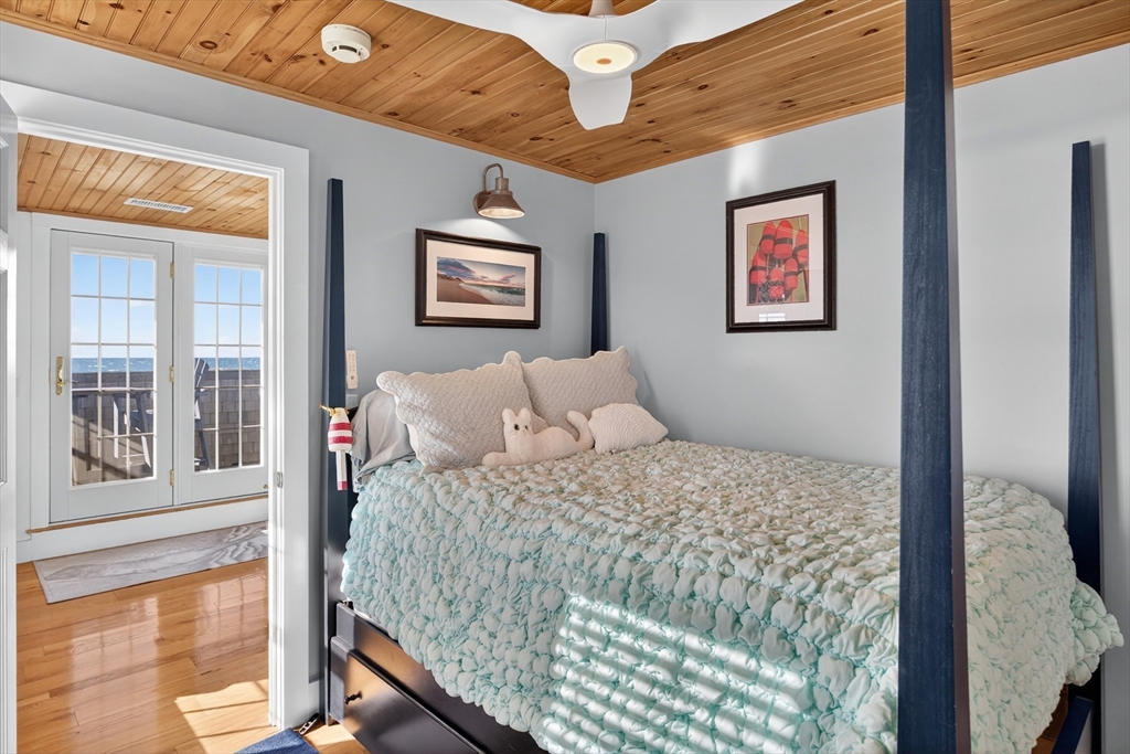 1145 Kingsbury Beach Road Eastham, MA 02642 - Photo 32 of 42 a bedroom with a bed and a large window