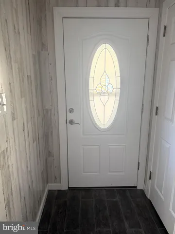 a view of a small space with wooden floor and a window