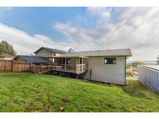 a view of a house with a yard and sitting area