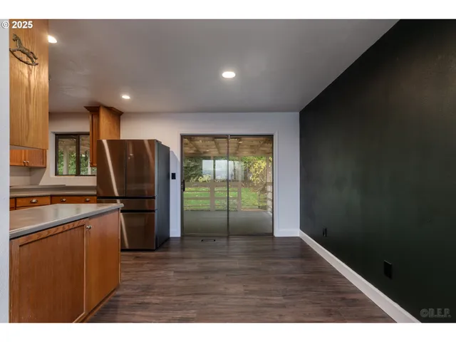 a open kitchen with stainless steel appliances granite countertop a refrigerator a sink a stove and island