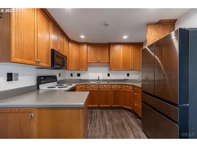 a kitchen with a refrigerator sink and cabinets