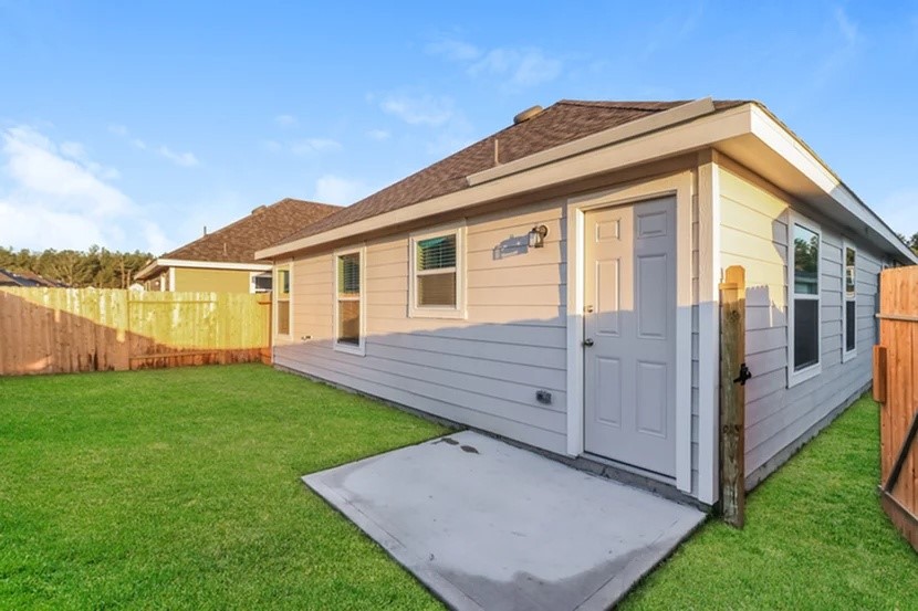 22336 Merlin Street Splendora, TX 77372 - Photo 2 of 19 a view of a house with a yard