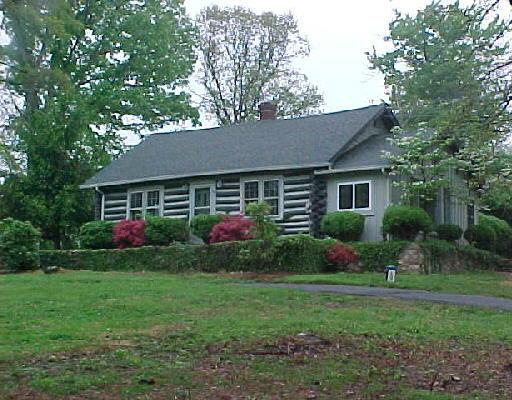 1706 Blue Ridge Springs Road Blue Ridge, VA 24064 - Photo 1 of 14 a front view of a house with garden