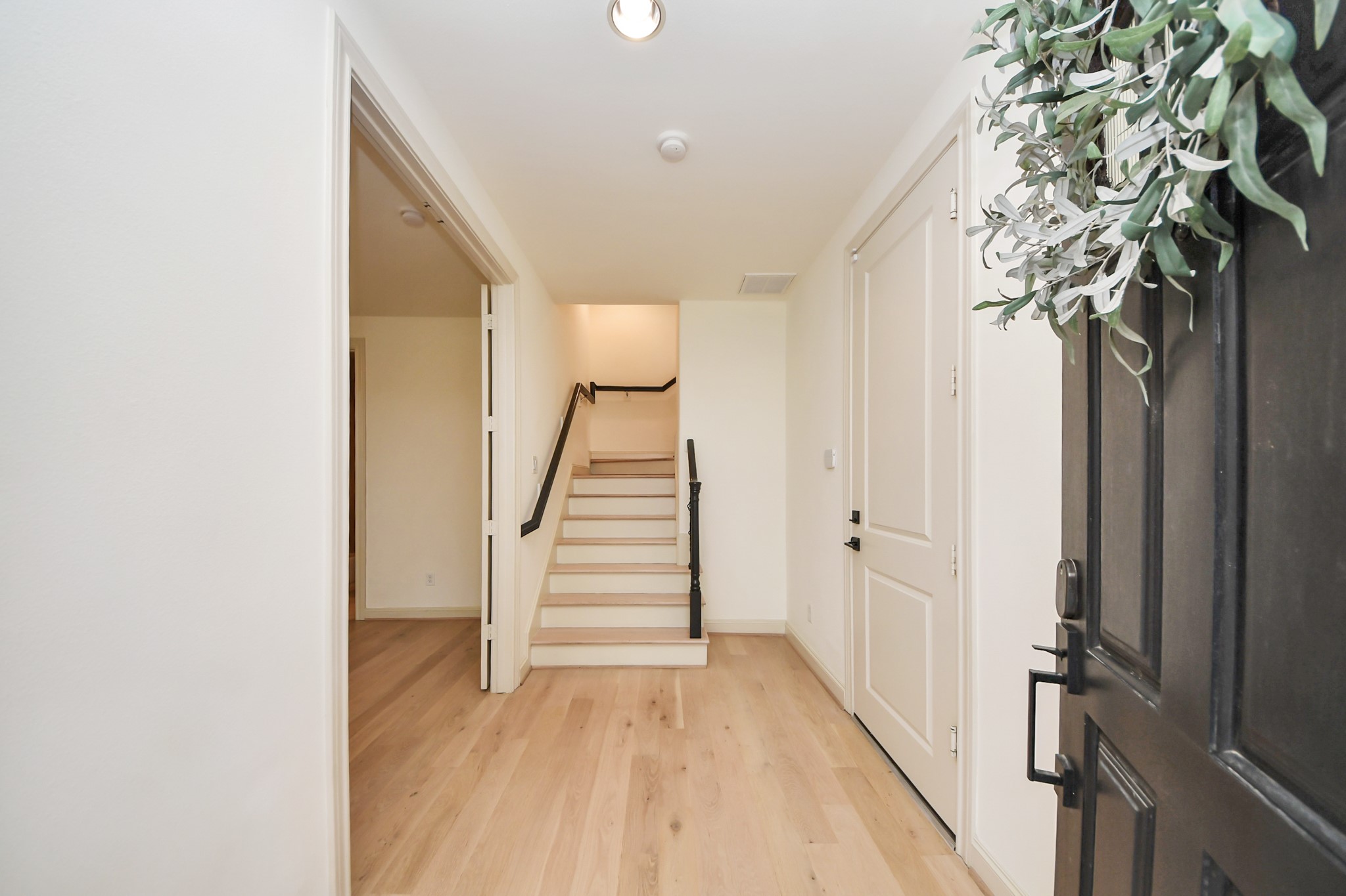 3229 Maxroy Street Houston, TX 77008 - Photo 6 of 43 A welcoming front entrance that opens to a versatile first-floor flex space, perfect for a guest suite with its own bathroom, an office, or a home gym, featuring beautiful wood flooring throughout and absolutely no carpet.