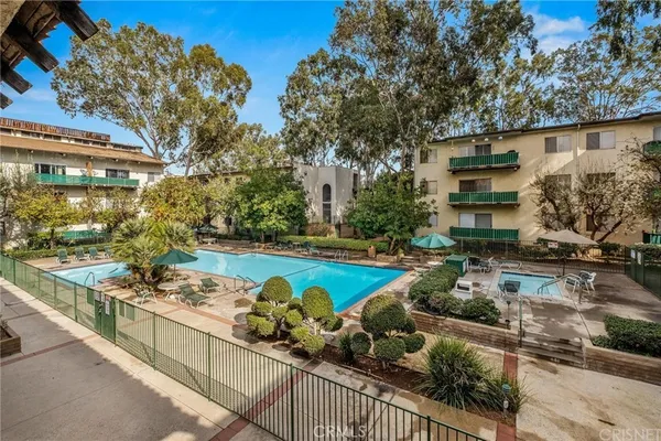 a view of house with swimming pool outdoor seating