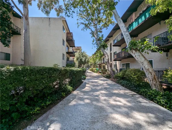 a man walking down a street next to a building