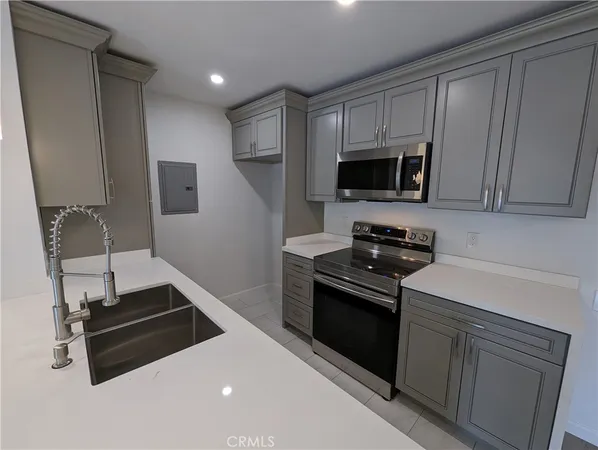 a kitchen with a sink and stainless steel appliances
