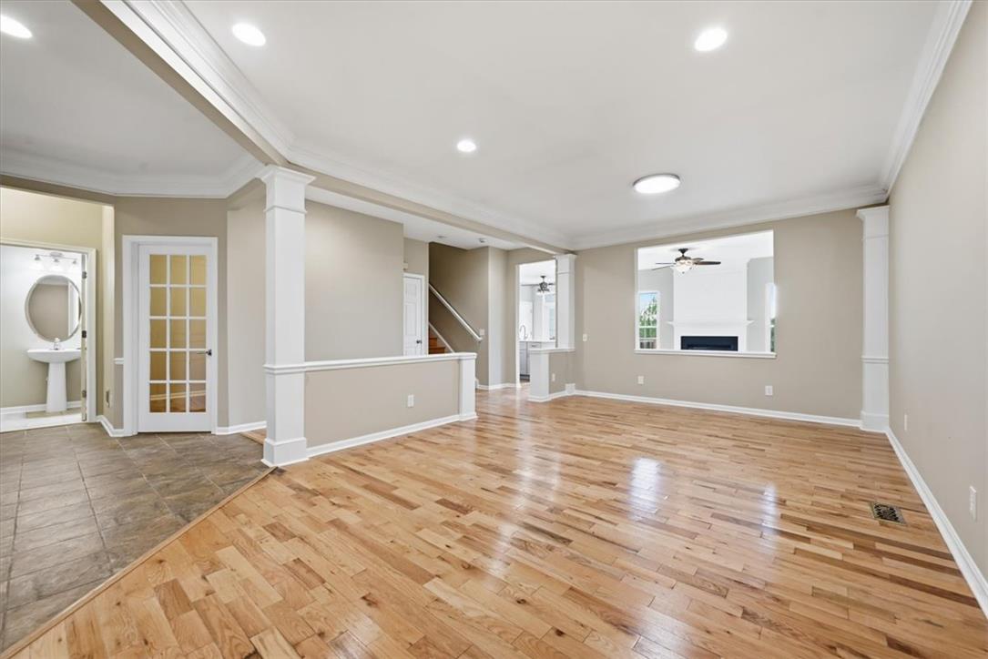 8761 Cascade Road Breinigsville, PA 18031 - Photo 31 of 84 Hardwood floors stretch across this versatile living space, accented by elegant crown molding and recessed lighting.