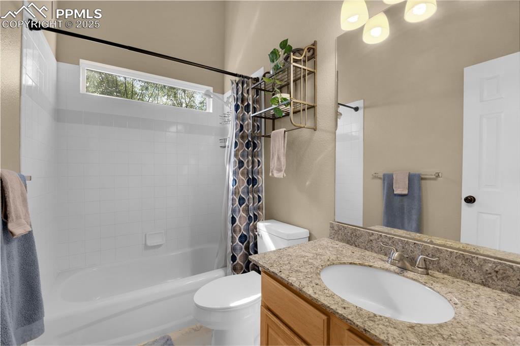 8534 Saddleman Road Peyton, CO 80831 - Photo 11 of 25 a bathroom with a granite countertop sink a toilet and shower