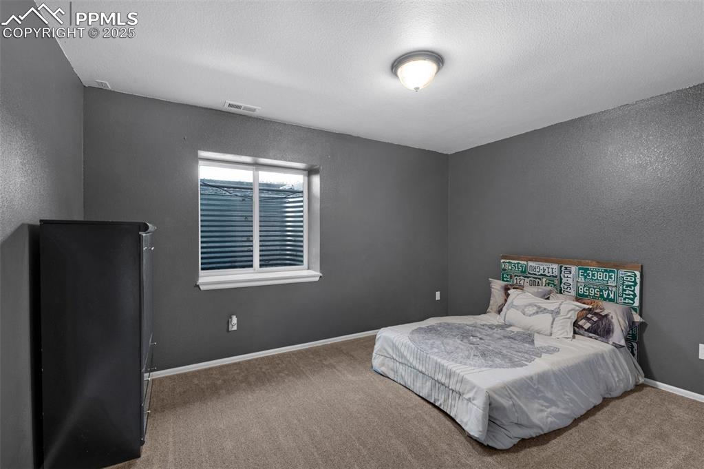 8534 Saddleman Road Peyton, CO 80831 - Photo 16 of 25 a bedroom with a bed and a window