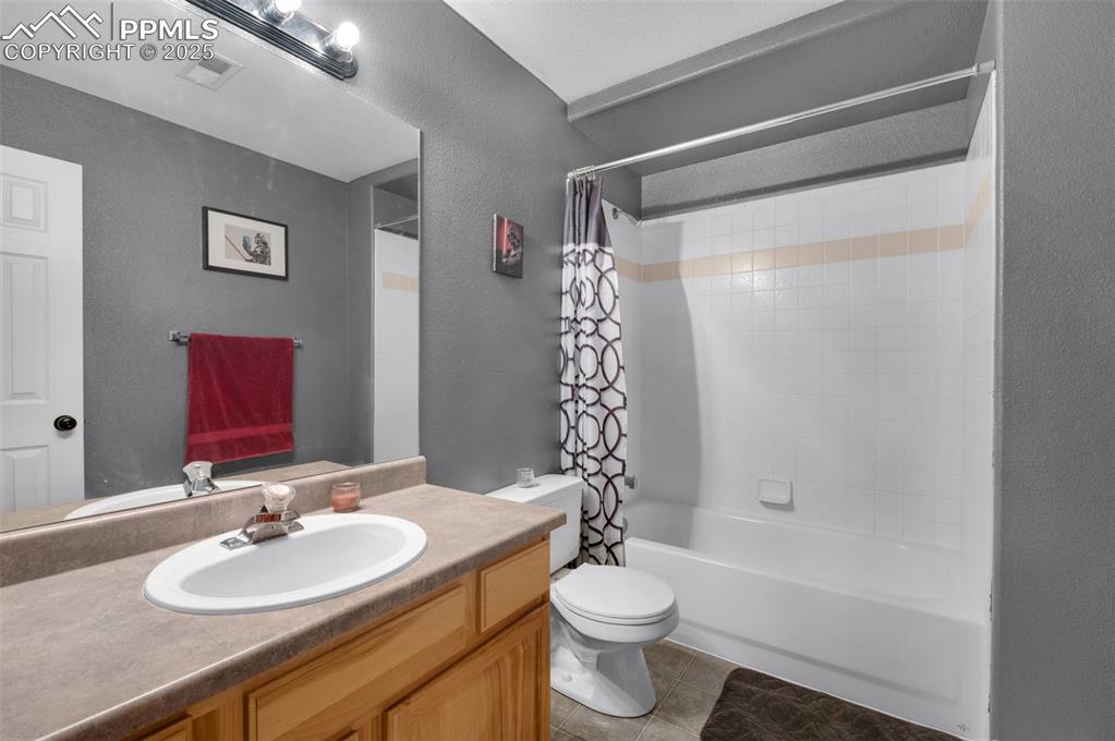 8534 Saddleman Road Peyton, CO 80831 - Photo 18 of 25 a bathroom with a sink toilet and shower