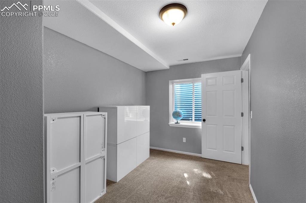 8534 Saddleman Road Peyton, CO 80831 - Photo 19 of 25 a view of an empty room with a window