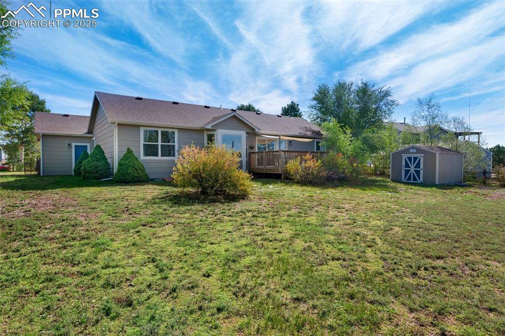8534 Saddleman Road Peyton, CO 80831 - Photo 21 of 25 a front view of a house with garden