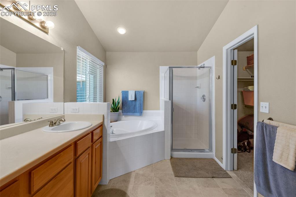 8534 Saddleman Road Peyton, CO 80831 - Photo 9 of 25 a bathroom with a double vanity sink mirror and shower