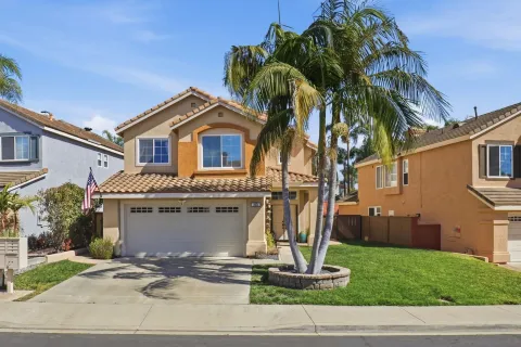 a front view of a house with a garden and plants