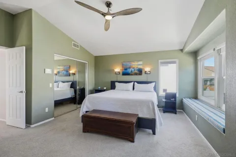 a bedroom with a bed and a large window