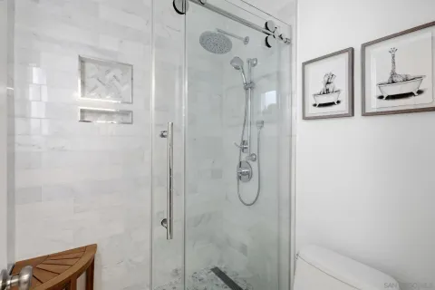 a bathroom with a shower and a shower