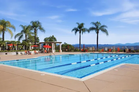 a view of a house with swimming pool and sitting area