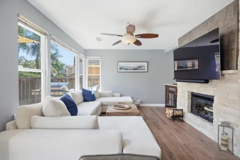 a living room with furniture fireplace and flat screen tv