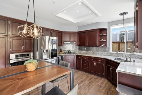 a kitchen with stainless steel appliances granite countertop a sink stove and refrigerator
