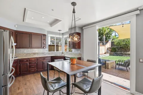 a dining room with a table chairs and a kitchen view
