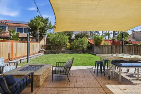 a view of a backyard with sitting area furniture and garden